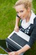 Beautiful young woman using laptop at outdoor
