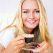 Closeup portrait of a pretty young female having a cup of coffee