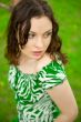 Closeup portrait of young beautiful woman wearing green dress si
