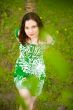 Closeup portrait of young beautiful woman wearing green dress si