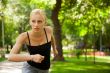 Portrait of young beautiful woman in sportswear running in park.