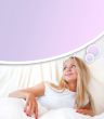Young blond woman enjoying a sunny morning in bed