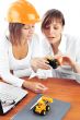 Portrait of two young women discussing construction project.