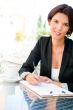 Closeup portrait of pretty woman sitting at cafe and signing doc