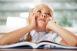 Portrait of a young girl in school at the desk.