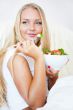 Closeup portrait of a beautiful slender girl eating healthy food