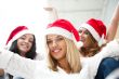 Group of three happy pretty girls are celebrating christmas and 