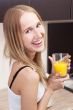 Portrait of beautiful relaxed young woman standing at the kitche
