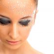 Portrait of young beautiful woman with crystals on face - isolat