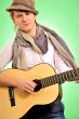 Closeup portrait of cute caucasian man playing the guitar over g