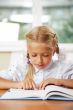 Portrait of a young girl in school at the desk.