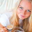 Closeup portrait of a pretty young female having a cup of coffee
