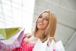 Beautiful woman at a shopping center with bags and smiling