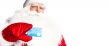 Traditional Santa Claus holding and sowing credit card while giv