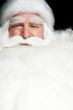 Santa Claus portrait smiling isolated over a black background