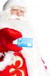 Traditional Santa Claus holding and sowing credit card while giv
