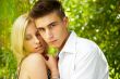 An attractive young woman embracing her handsome boyfiend