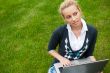 Beautiful young woman using laptop at outdoor