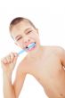 Beautiful boy brushing teeth, isolated on white