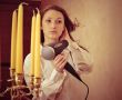 Beautiful woman drying her hair with hairdryer