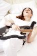 Teen girl holding a guitar like a rock star and enjoying playing