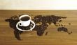 Dramatic photo of world map made of coffee beans. White cup with