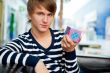 Portrait of young man inside shopping mall sitting relaxed on co
