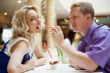 Closeup portrait of young cute couple at mall cafe. Man proposin