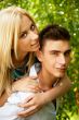 Portrait of love couple embracing outdoor in park looking happy