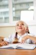 Portrait of a young girl in school at the desk.