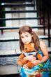 Artistic lifestyle photo of cute little girl outdoor sitting at 