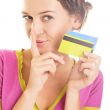 Beautiful young woman looks down at colorful credit cards in her