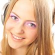Beautiful woman with headphones, she is listening to the music