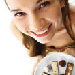beautiful woman showing plate full of of chocolate candies in a 
