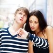 Portrait of young couple standing together at airport hall and l