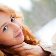 Portrait of beautiful red hair girl relaxing and looking at came