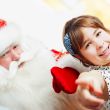 Christmas theme: Santa Claus and little girl having a fun. Indoo
