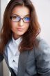 Beautiful young business woman wearing glasses sitting relaxed a