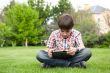 Young boy outdoors on the grass at backyard