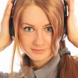Young woman wearing headphones listening to the language course