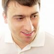 Closeup portrait of a happy young man smiling on white backgroun