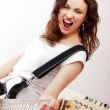 Portrait of beautiful young and attractive womanplaying her guit