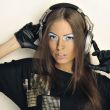 Rock style woman with headphones listening to music