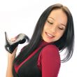 Beautiful European young woman shopping against white wall indoo