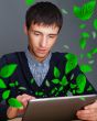 Portrait of young man sitting indoors at his office and working.