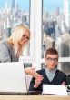 Young and successful smiling business people are working in the 