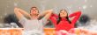 Smiling beautiful couple sitting on a sofa at their apartment an