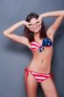 20-25 years old beautiful woman in swimsuit with american flag a