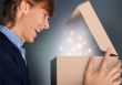 Portrait of young man received christmas gift. He opened gift bo