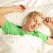 A peaceful man in his bed before waking up in his bedroom